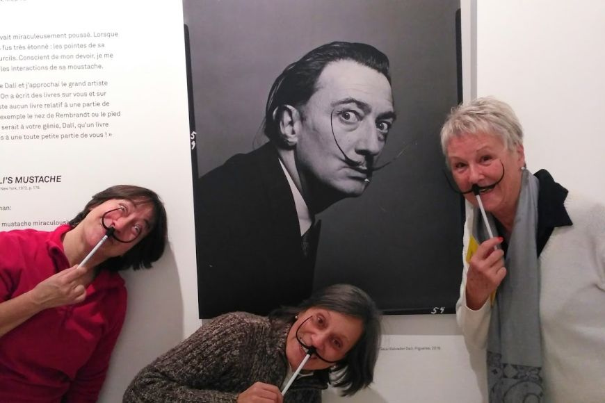 Tres de les participants a la Visitaamb els bigotis característics de Dalí